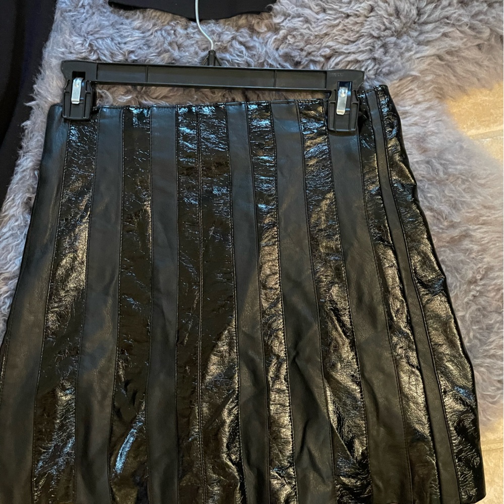 BEBE black skirt with patron leather strips